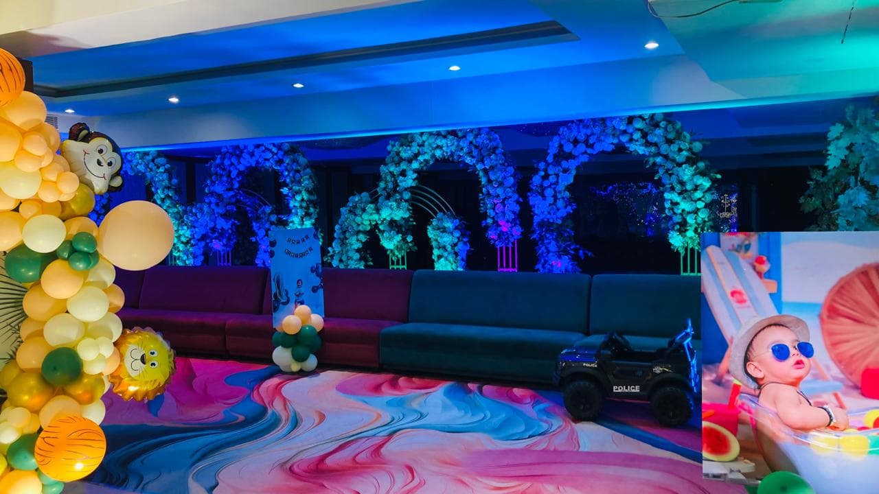 Birthday party with neon floral arches